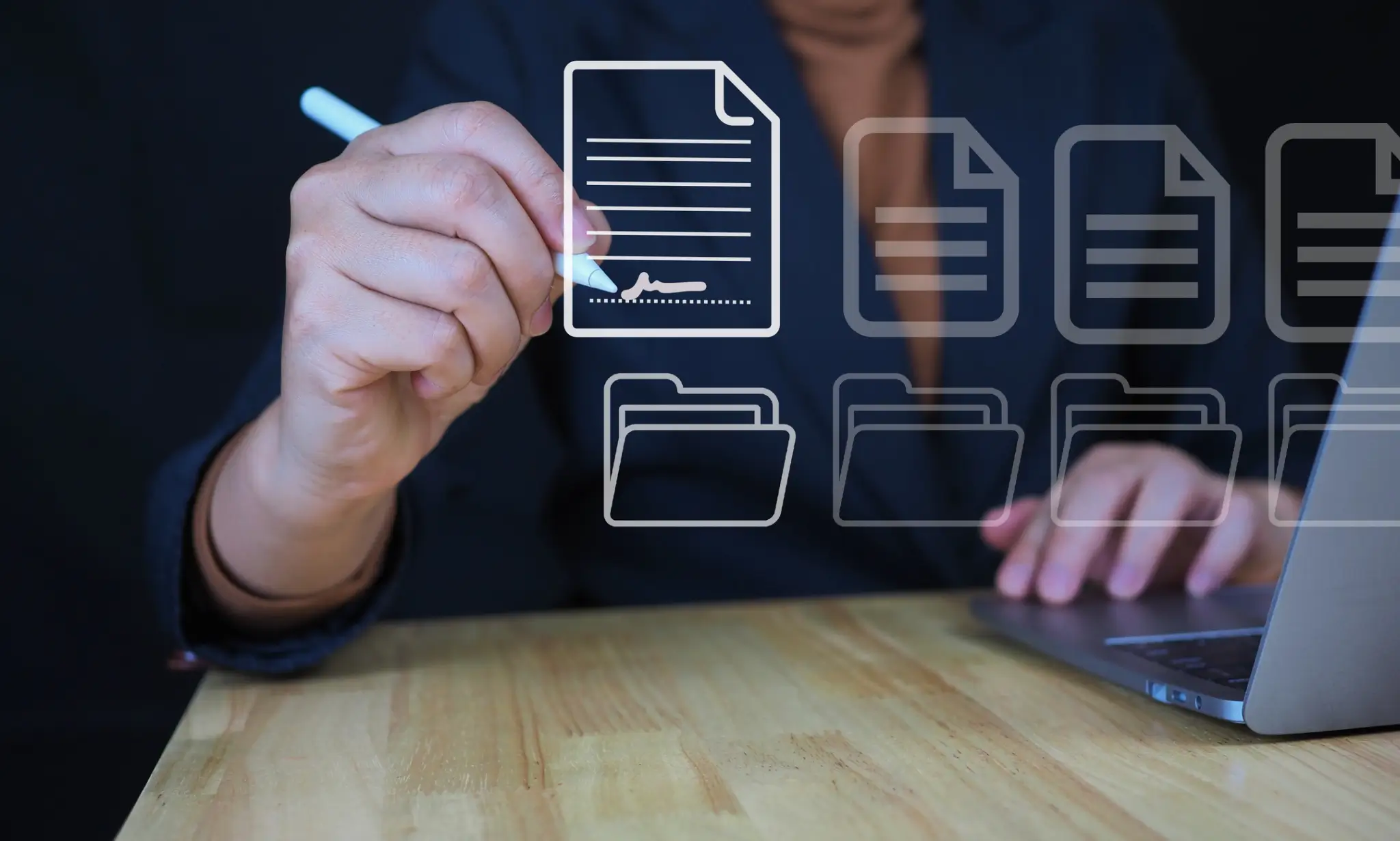 Hand signing digital documents on laptop